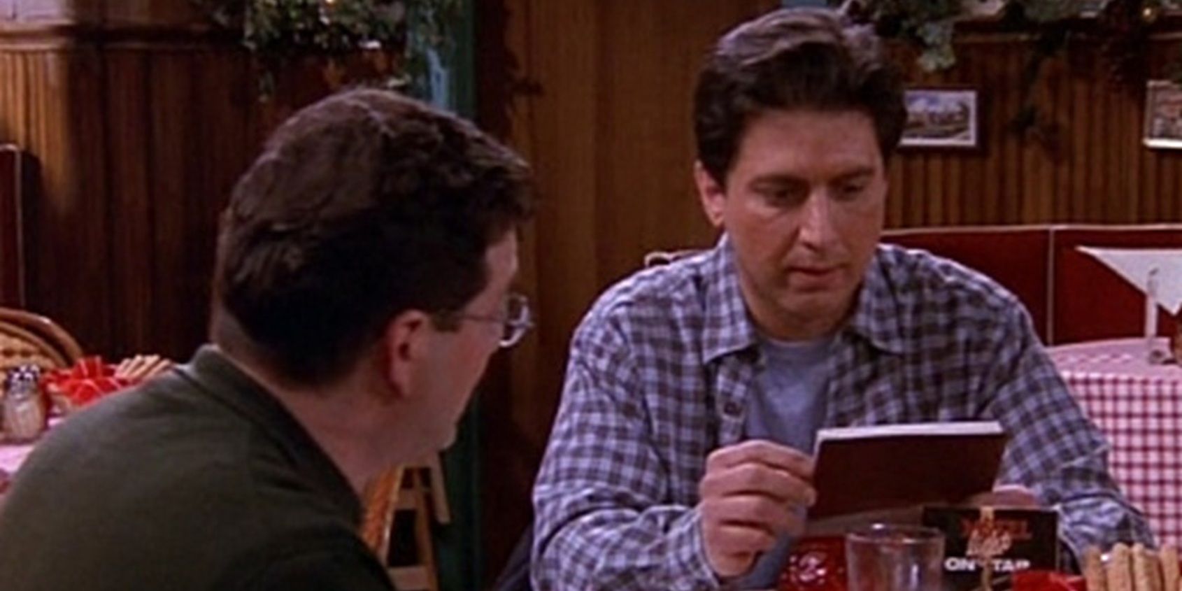Ray holding the family checkbook in everyone loves Raymond