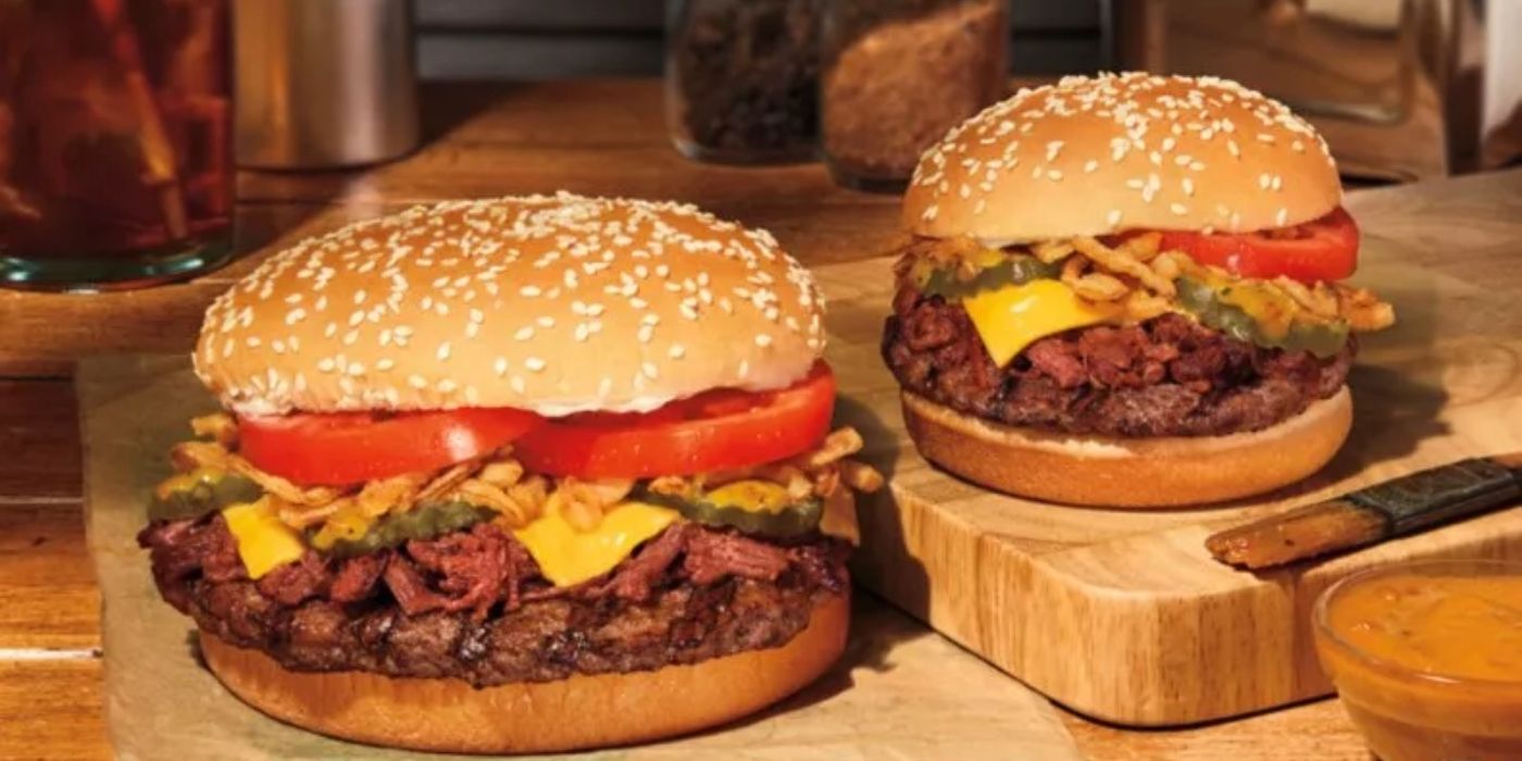 A closeup of 2 of Burger King's BBQ Brisket Whopper sandwiches overflowing with toppings