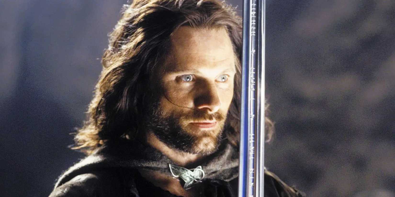 Aragorn holds up his sword while looking on in The Lord of the Rings: The Return of The King