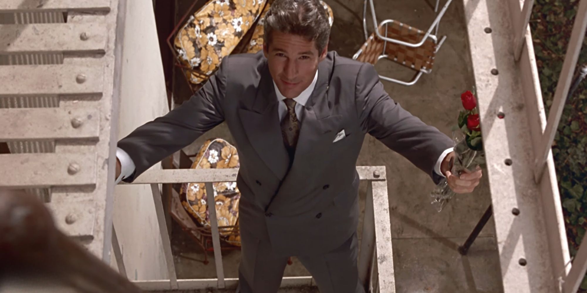 Richard Gere as Edward on the balcony with flowers  in Pretty Woman