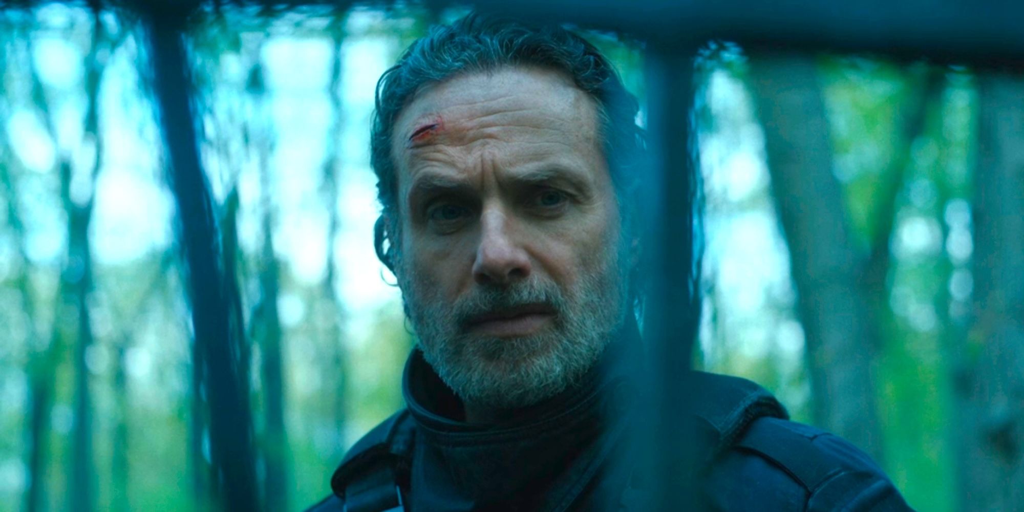 Rick Grimes looking through a fence with a wound on his head in The Walking Dead The Ones Who Live episode 6