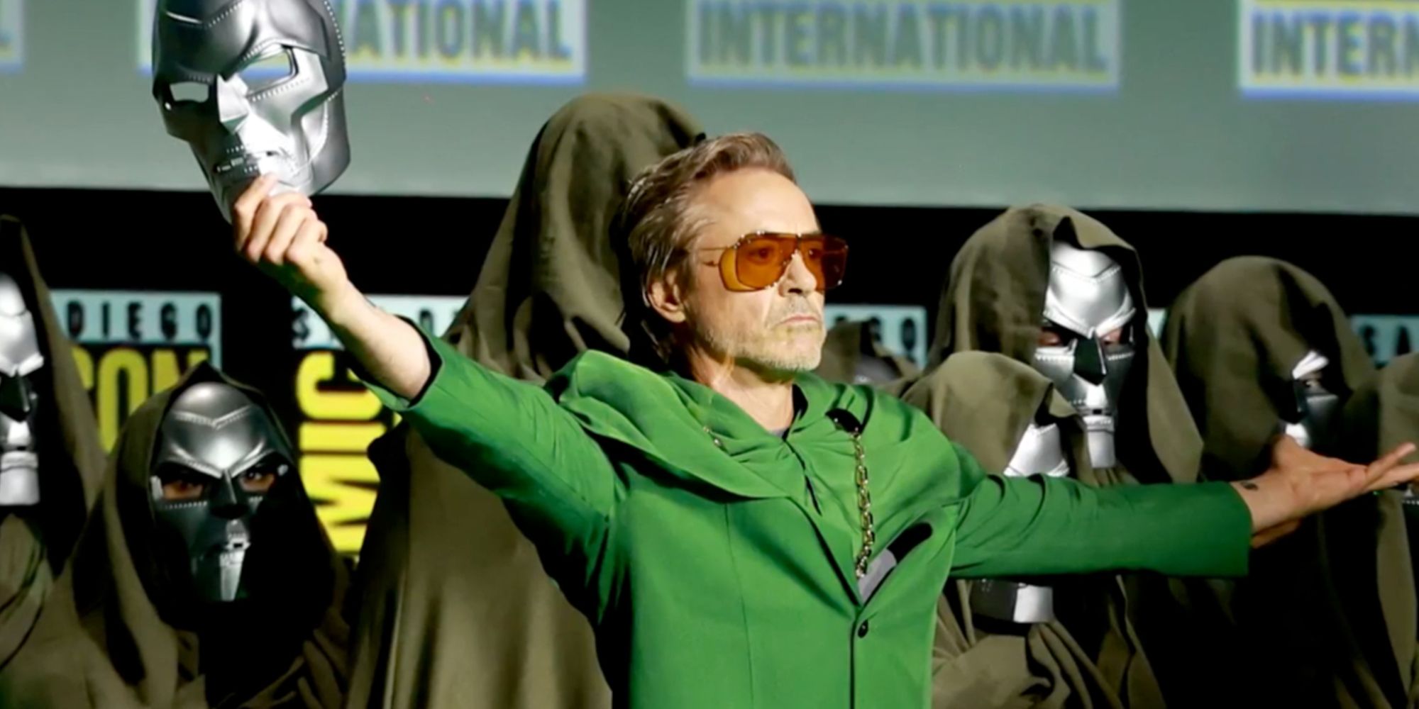 Robert Downey Jr. holding a Doom mask with his arms out at San Diego Comic-Con 2024