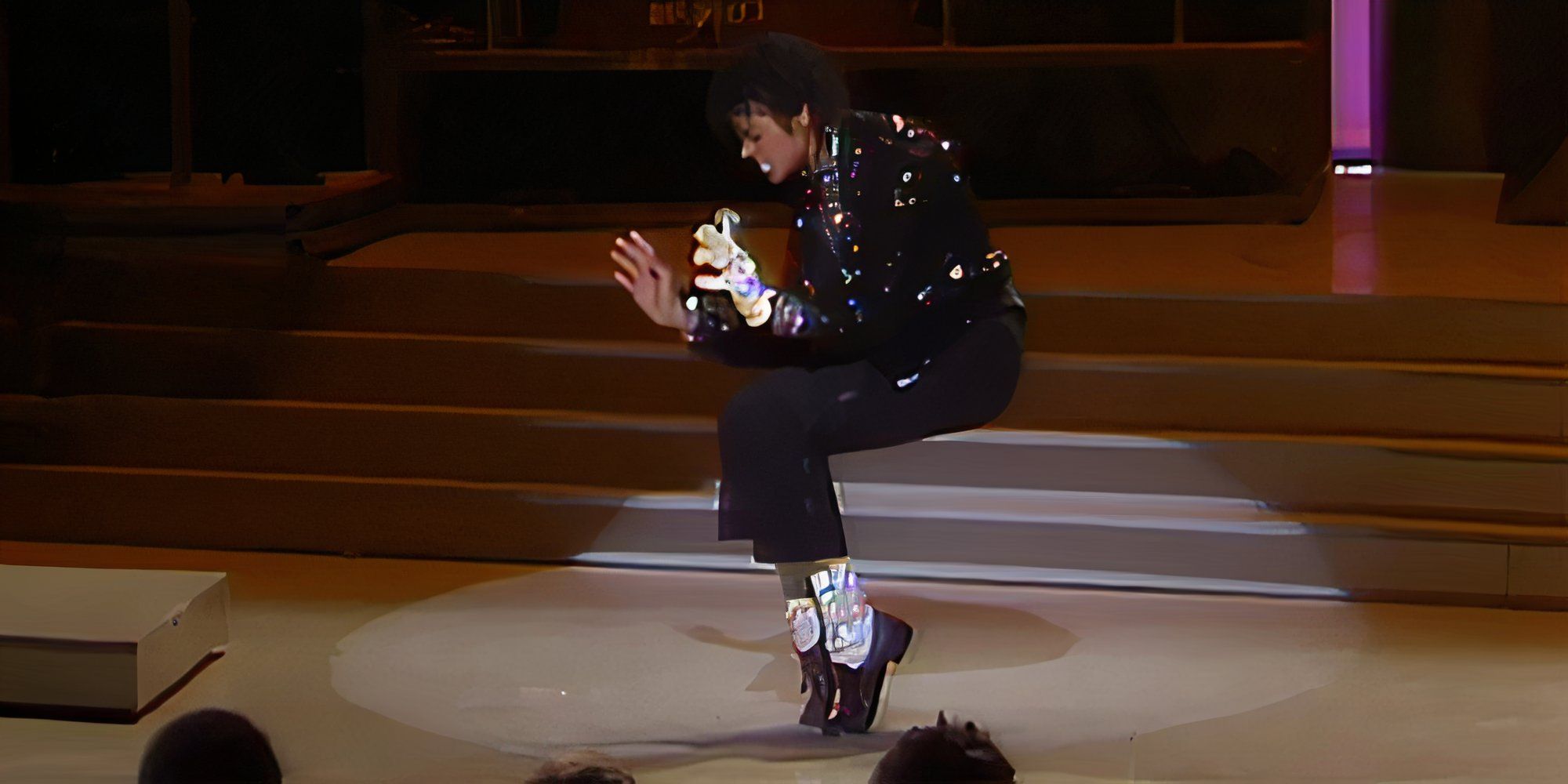 Michael Jackson performs "Billie Jean" at Motown 25 and hits a toe stand in his black sparkling jacket, white glove, and sparkling socks.