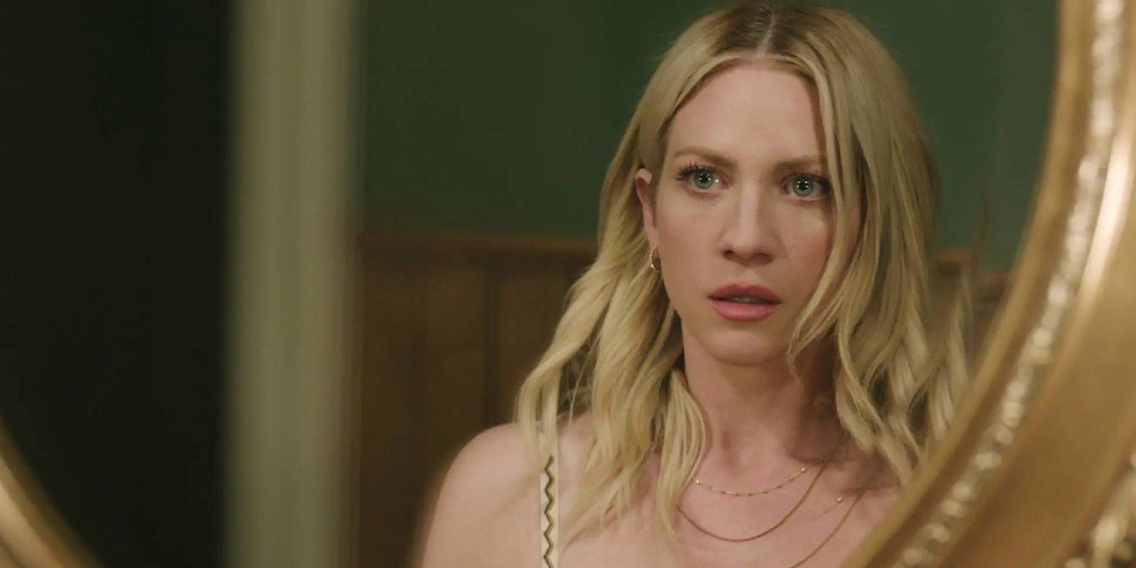 Sophie looks at her reflection in the mirror in The Hunting Wives season 1