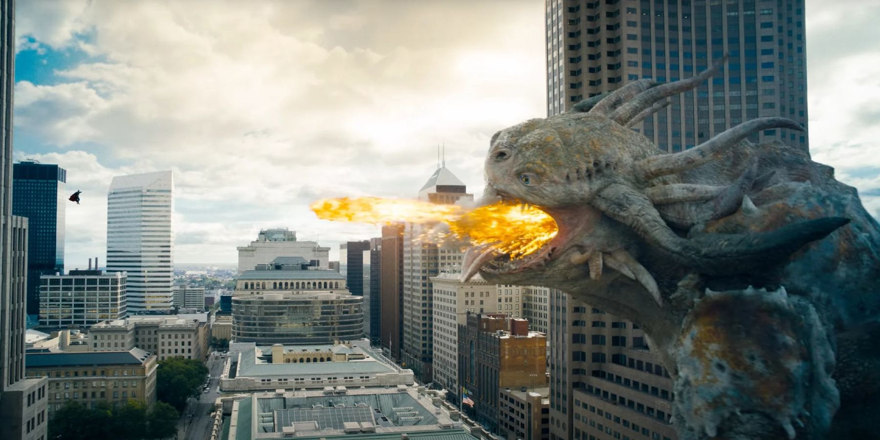 Superman fights the kaiju as it spits fire