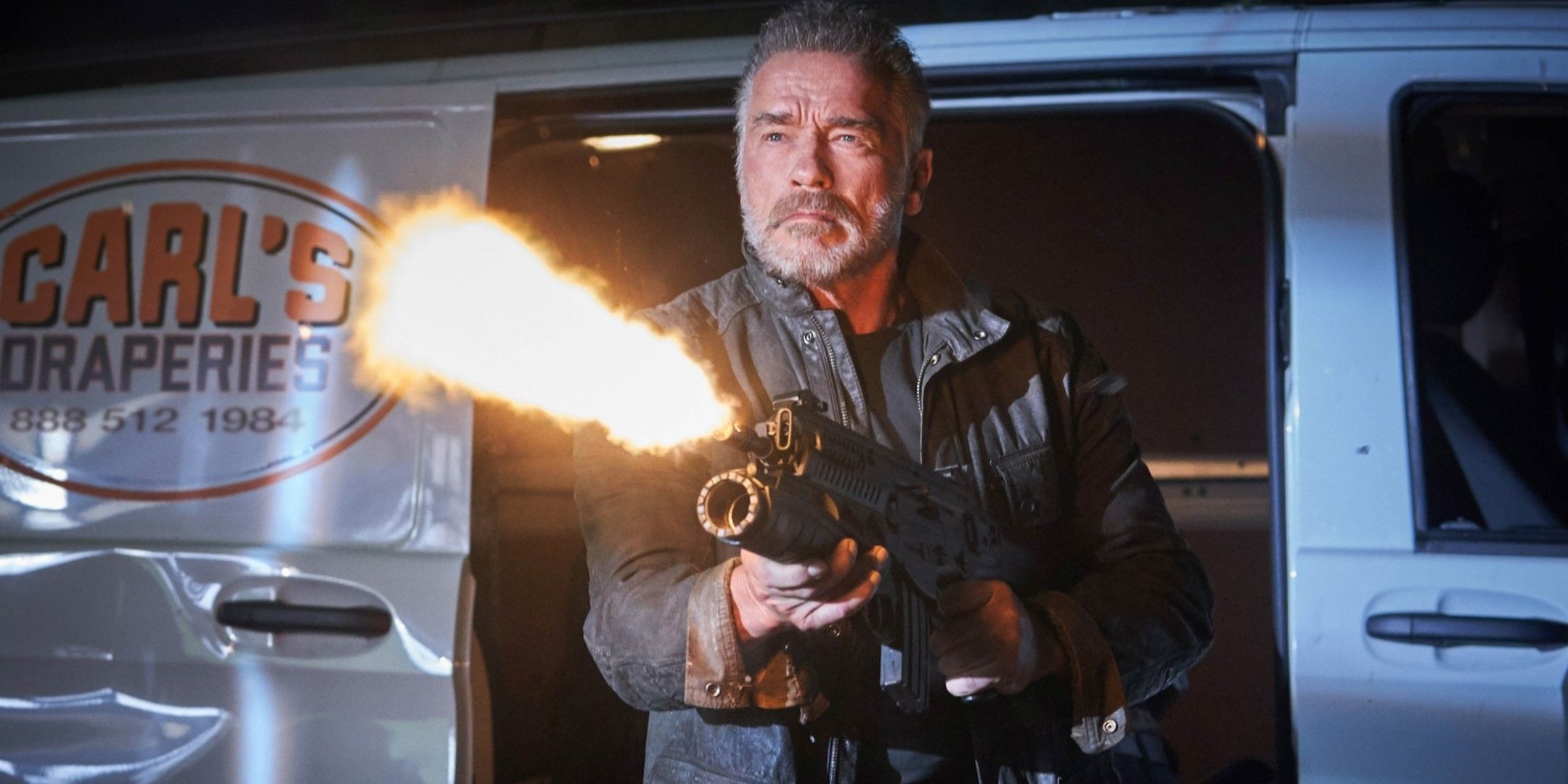 The T-800 fires a big gun while standing near his van in Terminator: Dark Fate