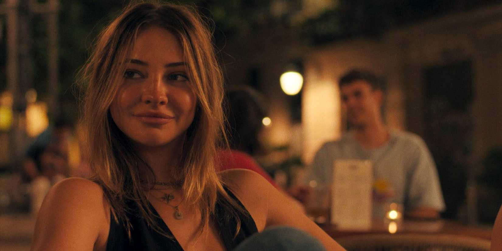 madelyn cline sits at a table in The Map That Leads to You
