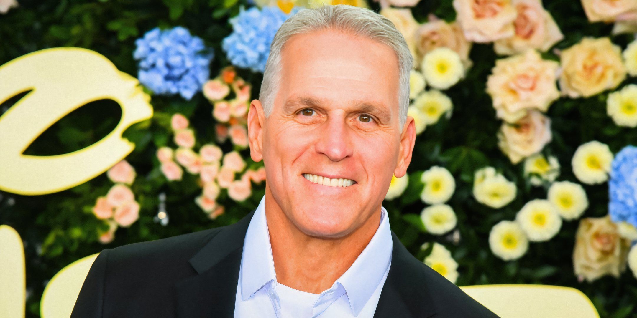 The Golden Bachelor season 2's Mel Owens smiling in front of a floral wall.