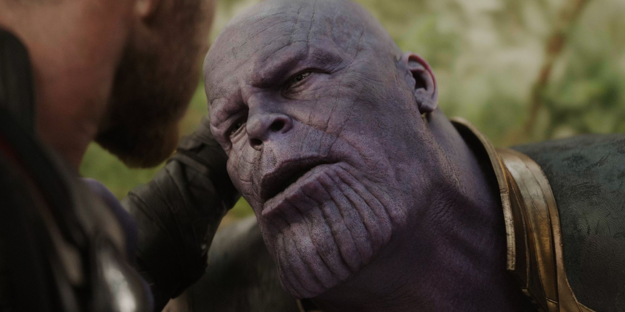 Thor holding Thanos' head as he stabs him in Avengers Infinity War
