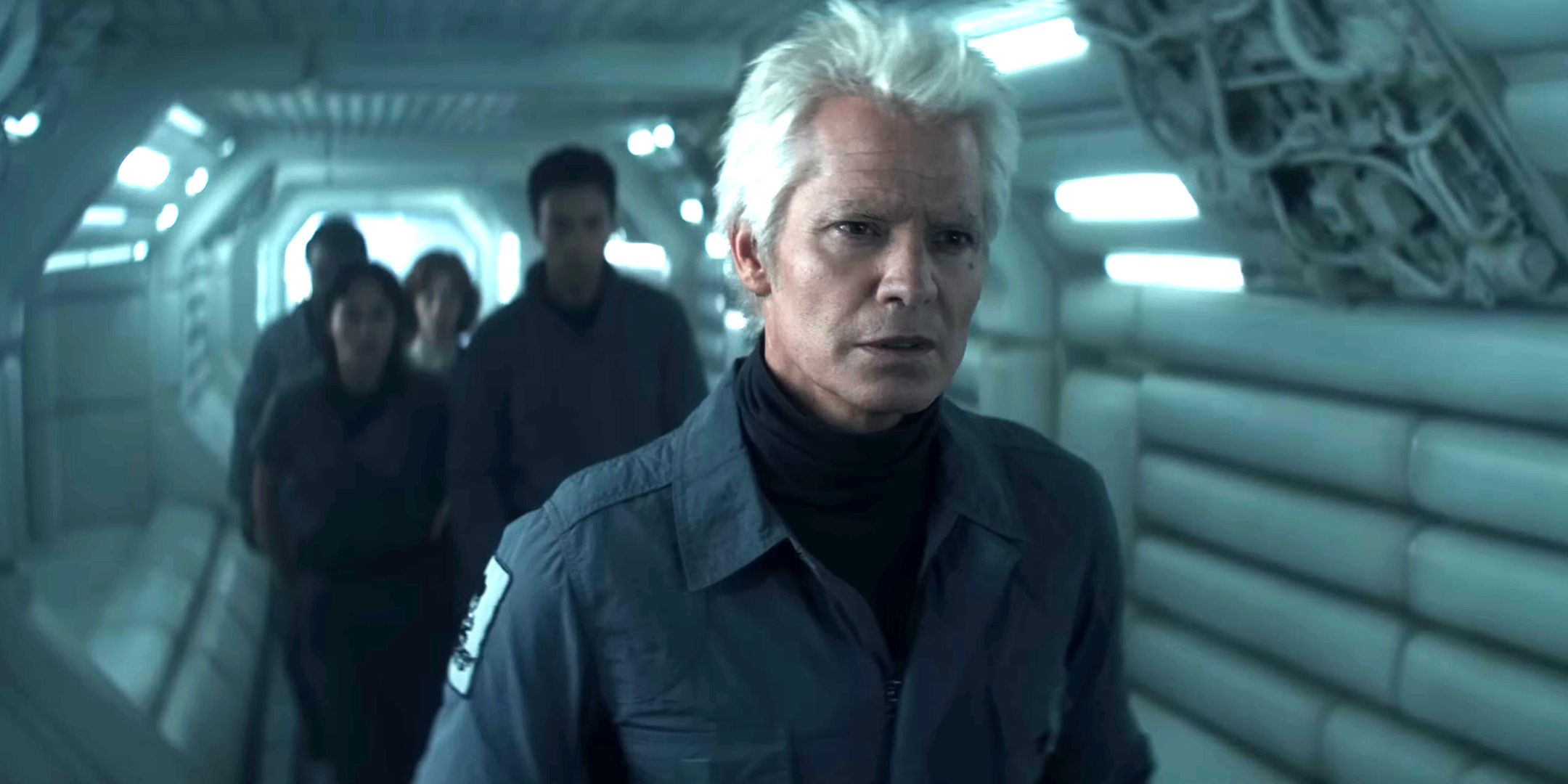 Timothy Olyphant and others walking cautiously down a ship hallway in Alien: Earth