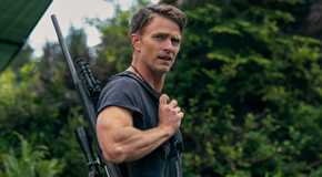 Wilson Bethel carrying a firearm over his shoulder and looking to the side in Untamed