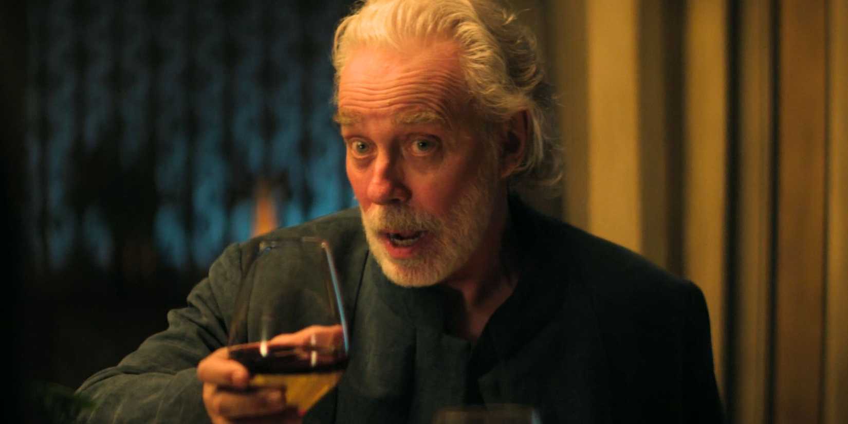 Terrence Mann holding a glass of wine as Brother Dusk in Foundation