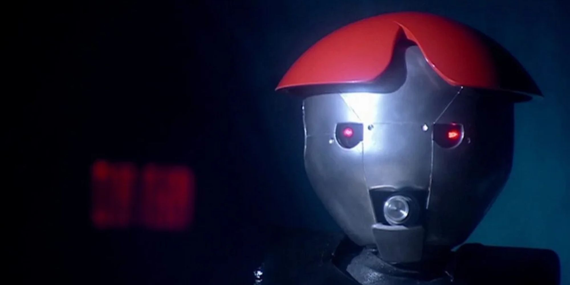 The Anne Droid with her mouth open, about to fire a shot on The Weakest Link set, in the Doctor Who season 1 episode "Bad Wolf."