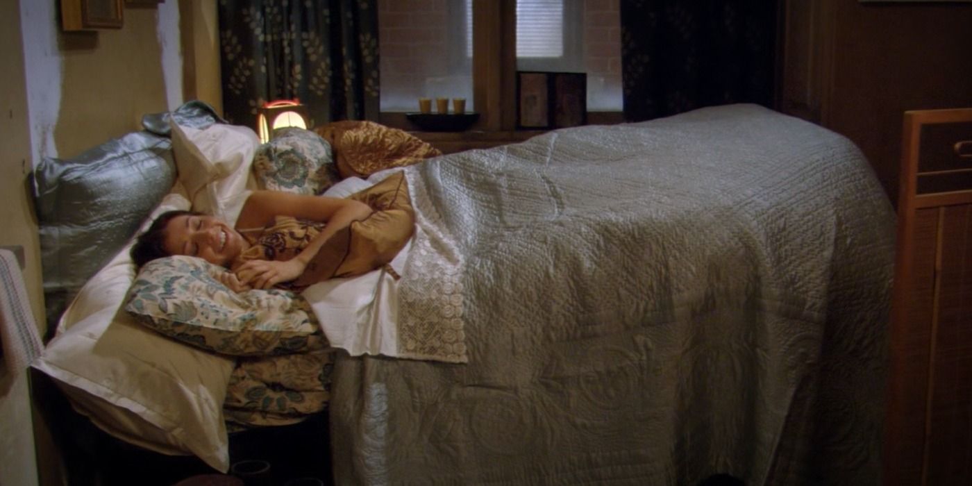 Lily laying in bed, surrounded by the sheets and pillows from Barney, in the How I Met Your Mother season 2 episode "World's Greatest Couple."