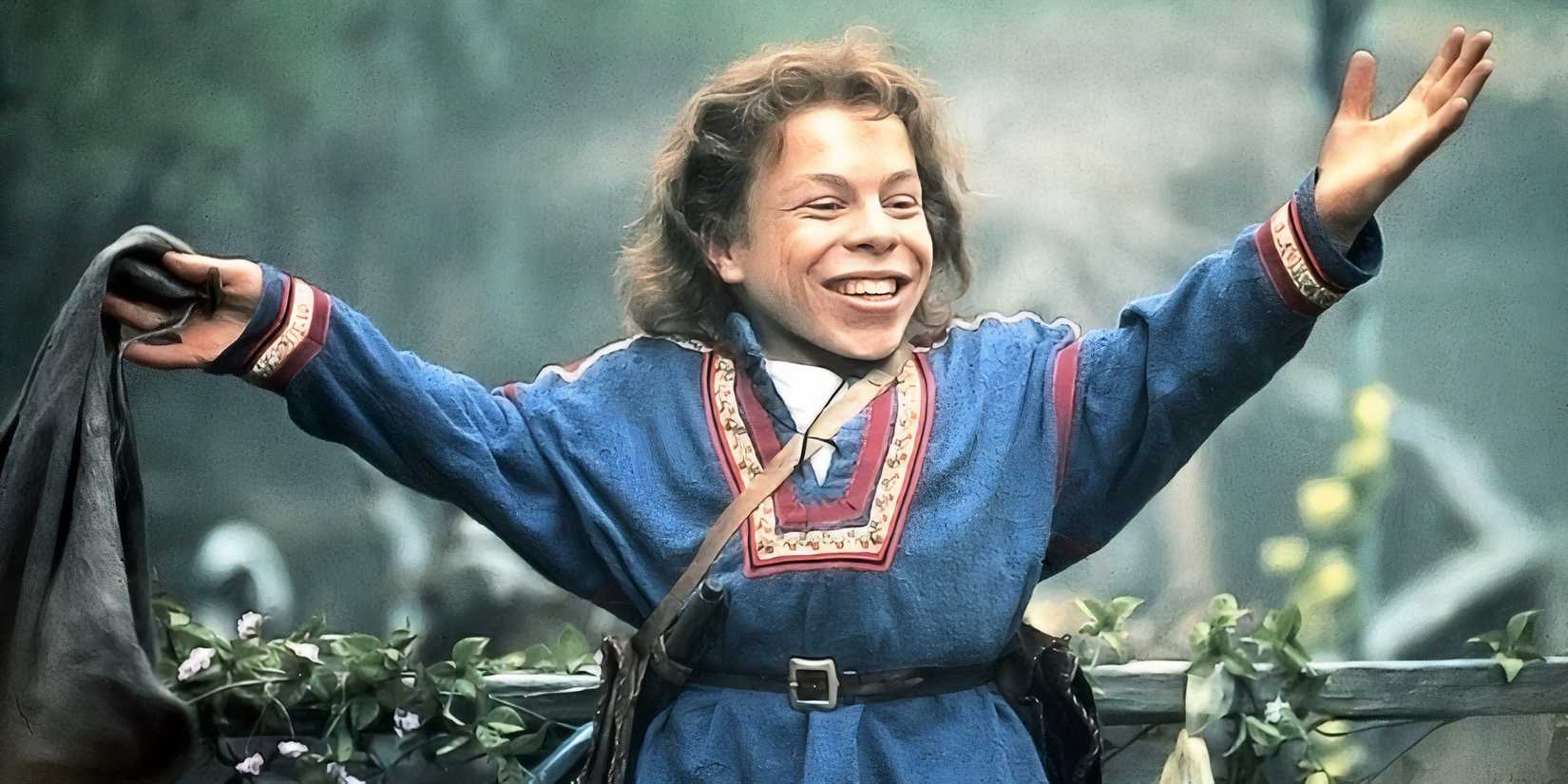 Willow smiles with his arms outstretched in Willow