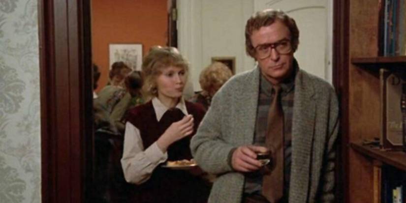 Mia Farrow behind Michael Caine at a party in Hannah and her Sisters