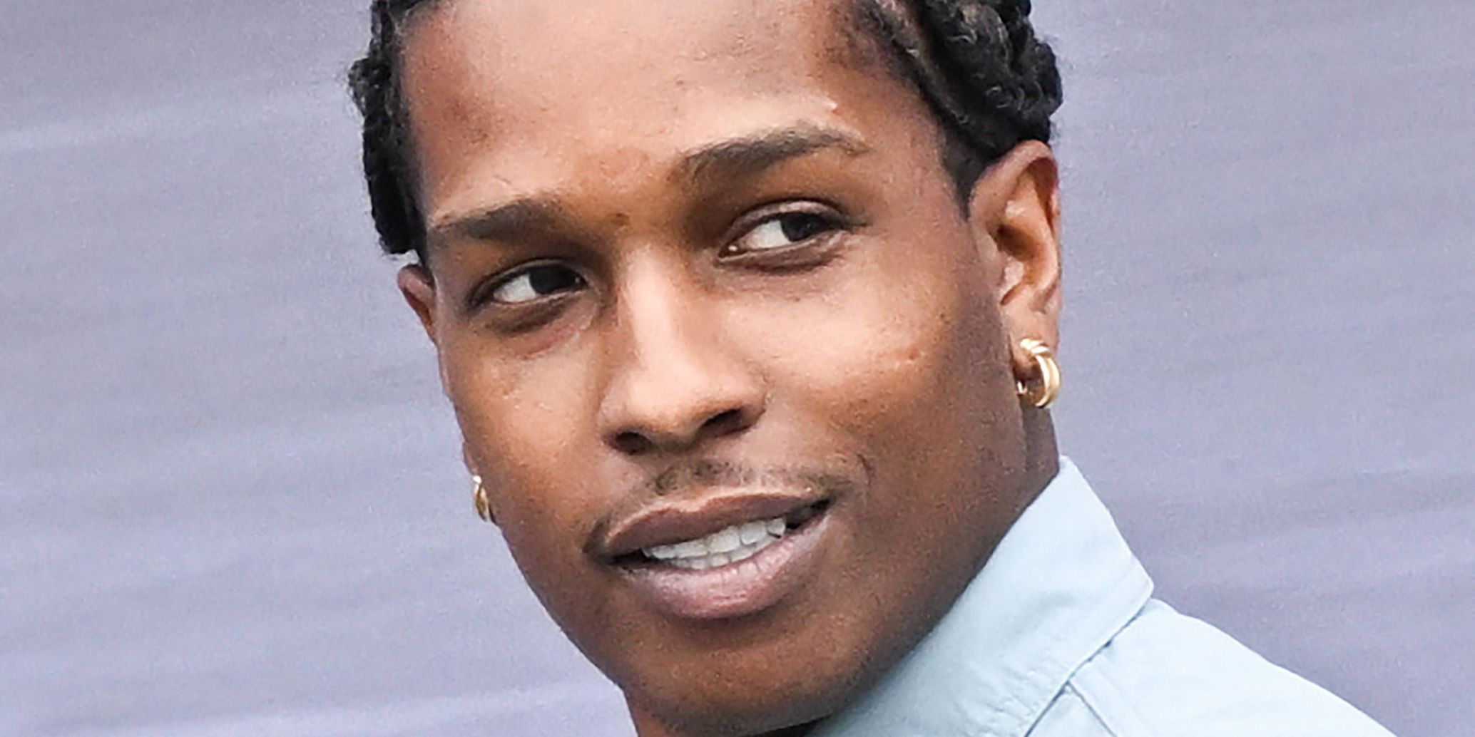 A$AP Rocky looking over his shoulder at a red carpet event