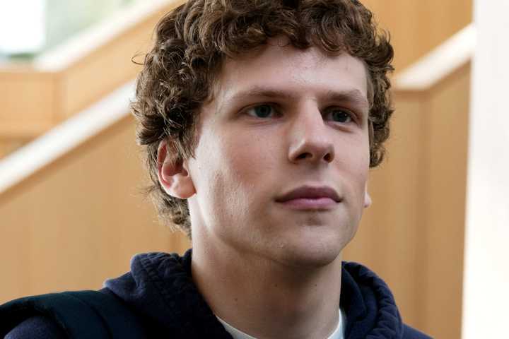 A close-up of Jesse Eisenberg looking smug in The Social Network