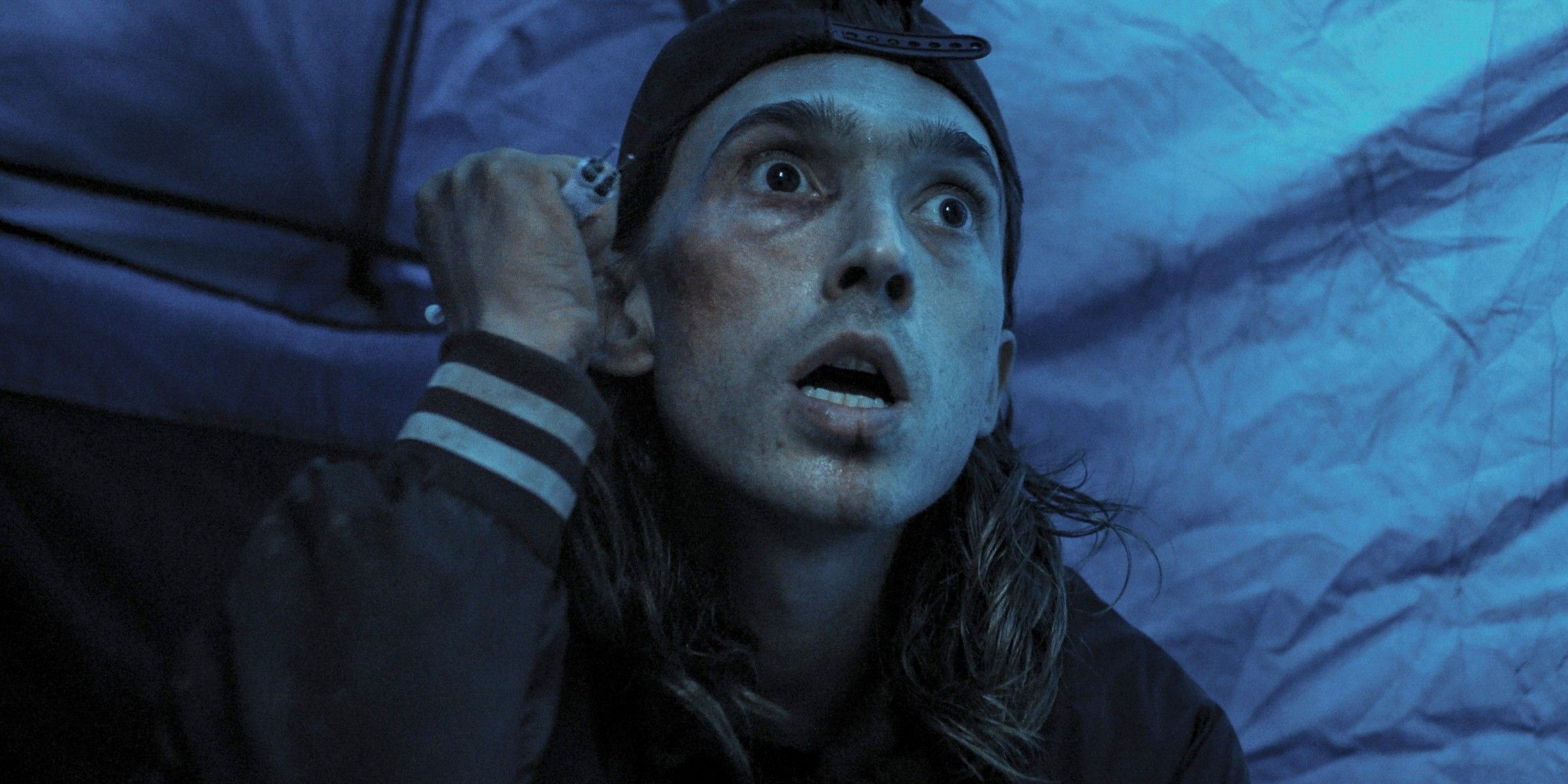 James (Austin Abrams) looking panicked and holding up a weapon in Weapons