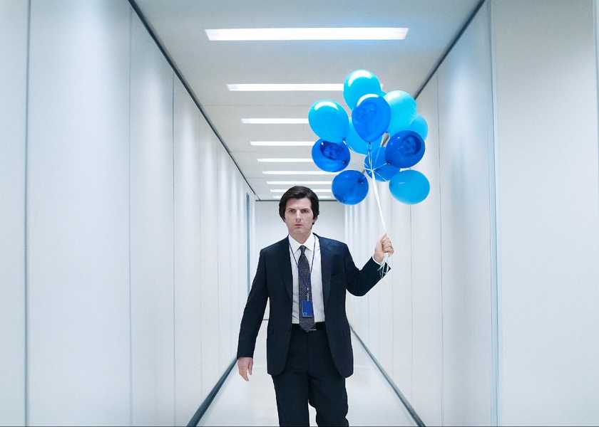 Adam Scott walks down a hallway with balloons in Severance
