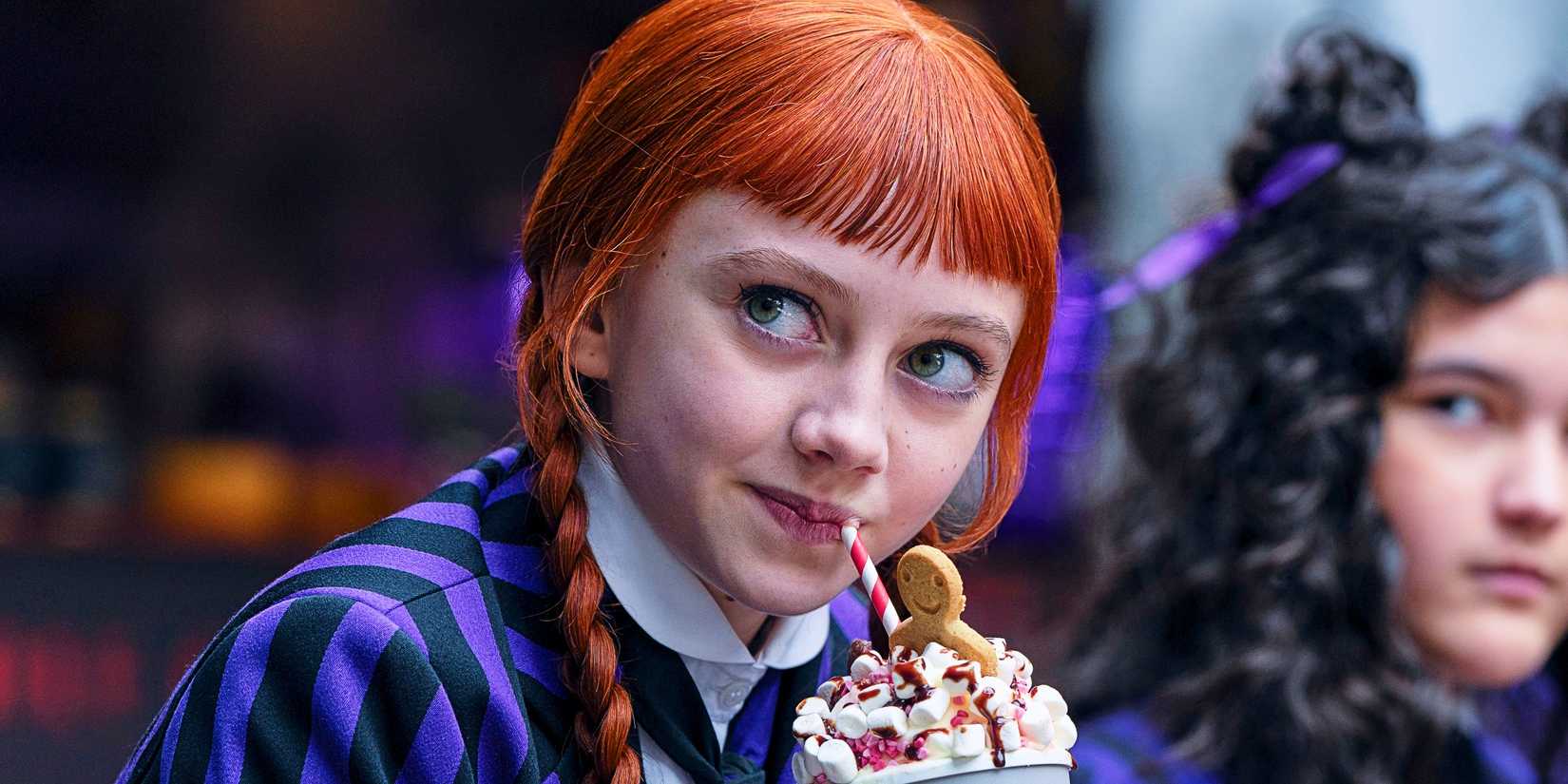 Agnes smiling and sipping on a drink in Wednesday season 2