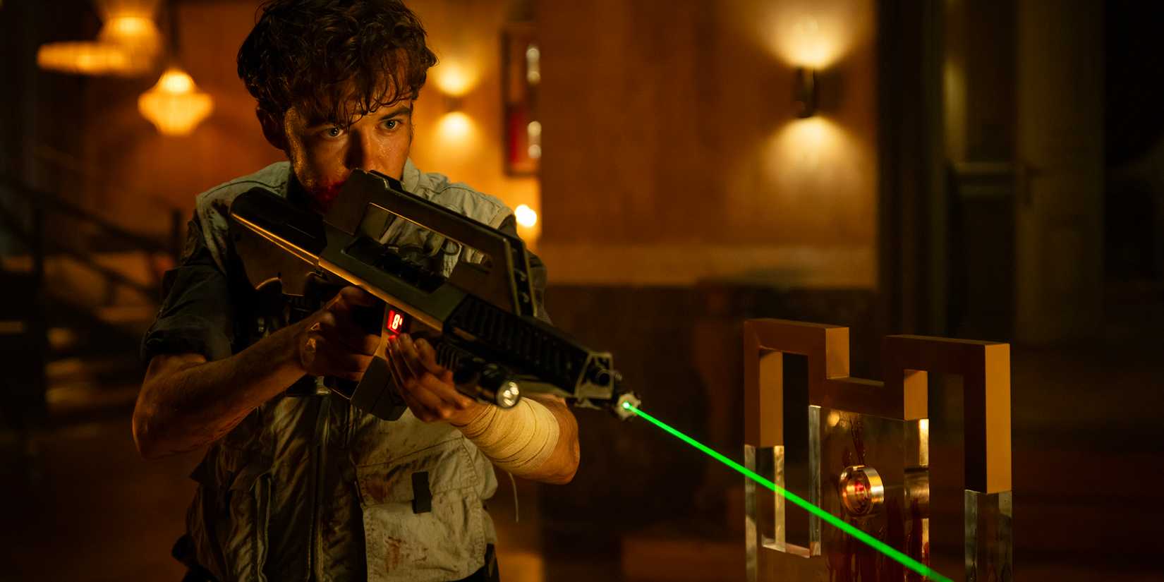 Alex Lawther pointing a gun in Alien Earth