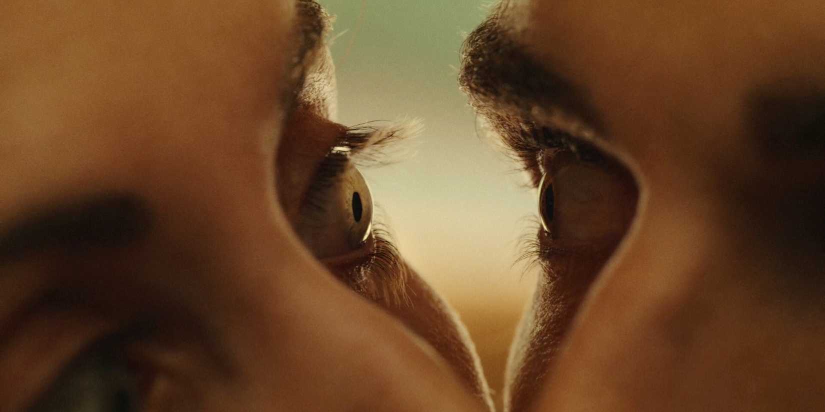 Two eyeballs stare into each other in close up in a scene from Together