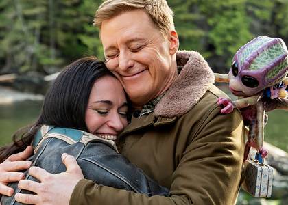 Asta, Harry and Bridget smiling while they hug goodbye in Resident Alien season 4 finale