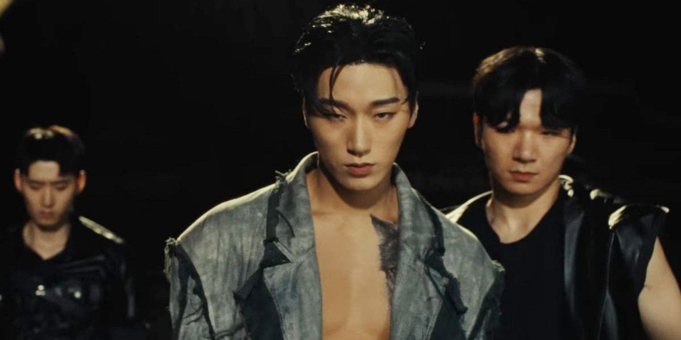Ateez's San in a music video staring at the camera