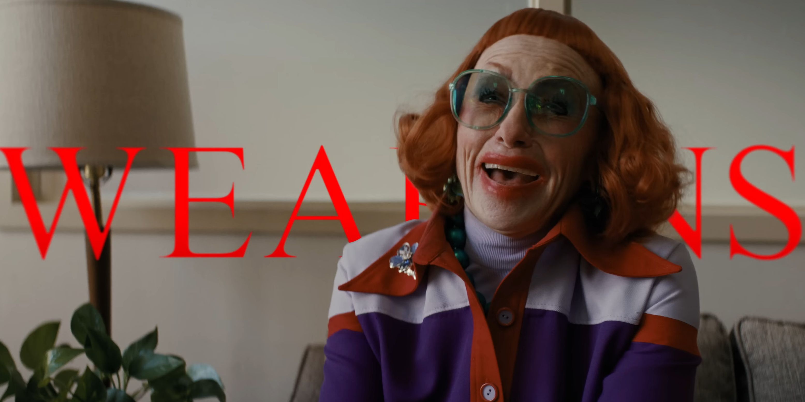 Aunt Gladys smiling with the movie тιтle behind her in the Weapons trailer