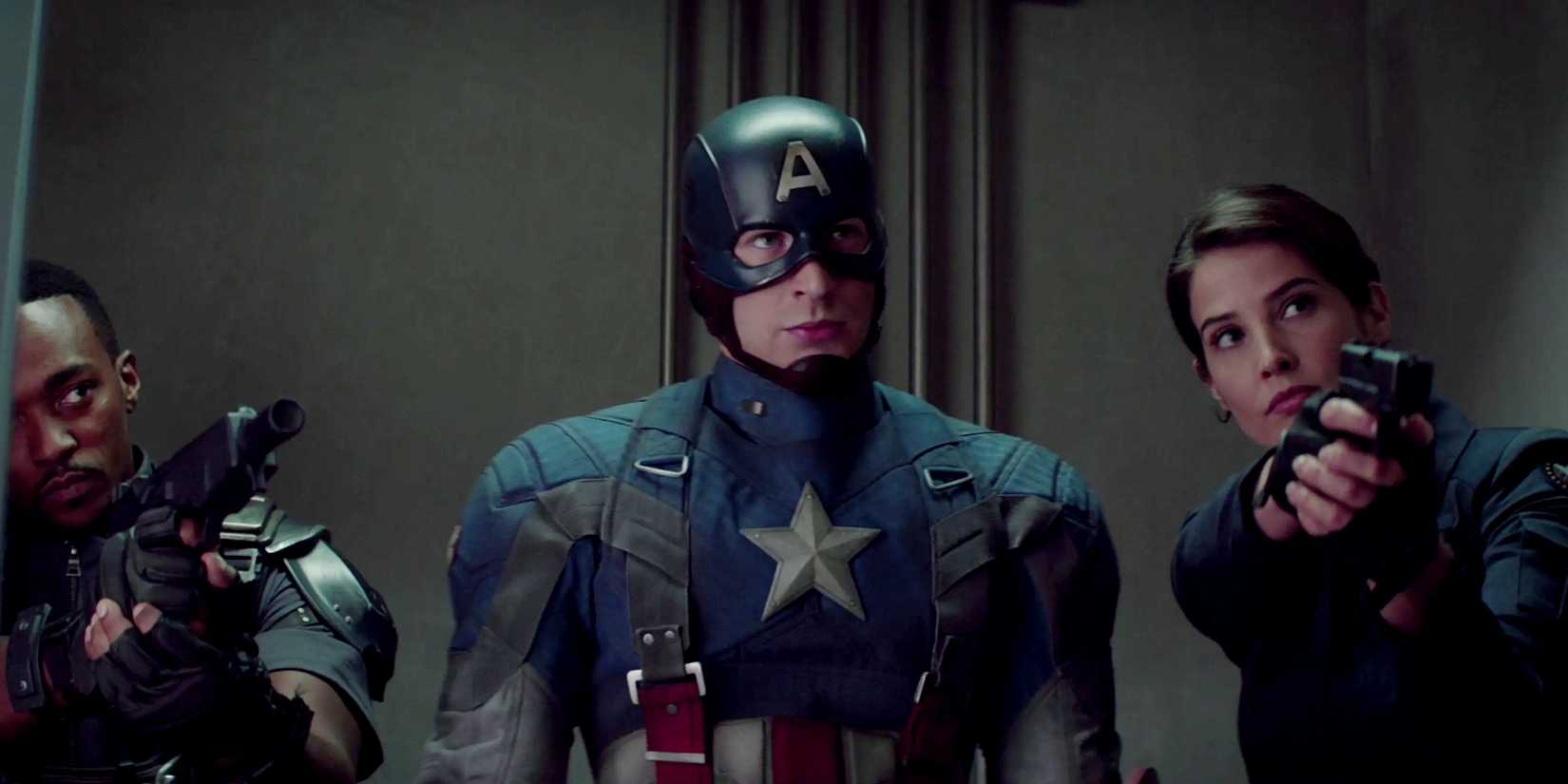 Captain America in full costume looking confident while Sam Wilson and Maria Hill hold guns beside him in Captain America the Winter Soldier-1