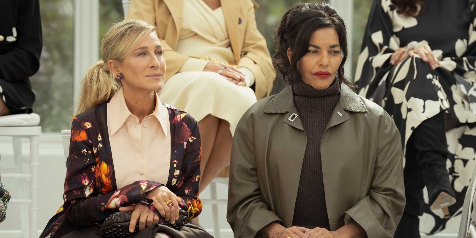 Carrie and Seema sitting next to each other at a fashion show in the And Just Like That season 3 finale