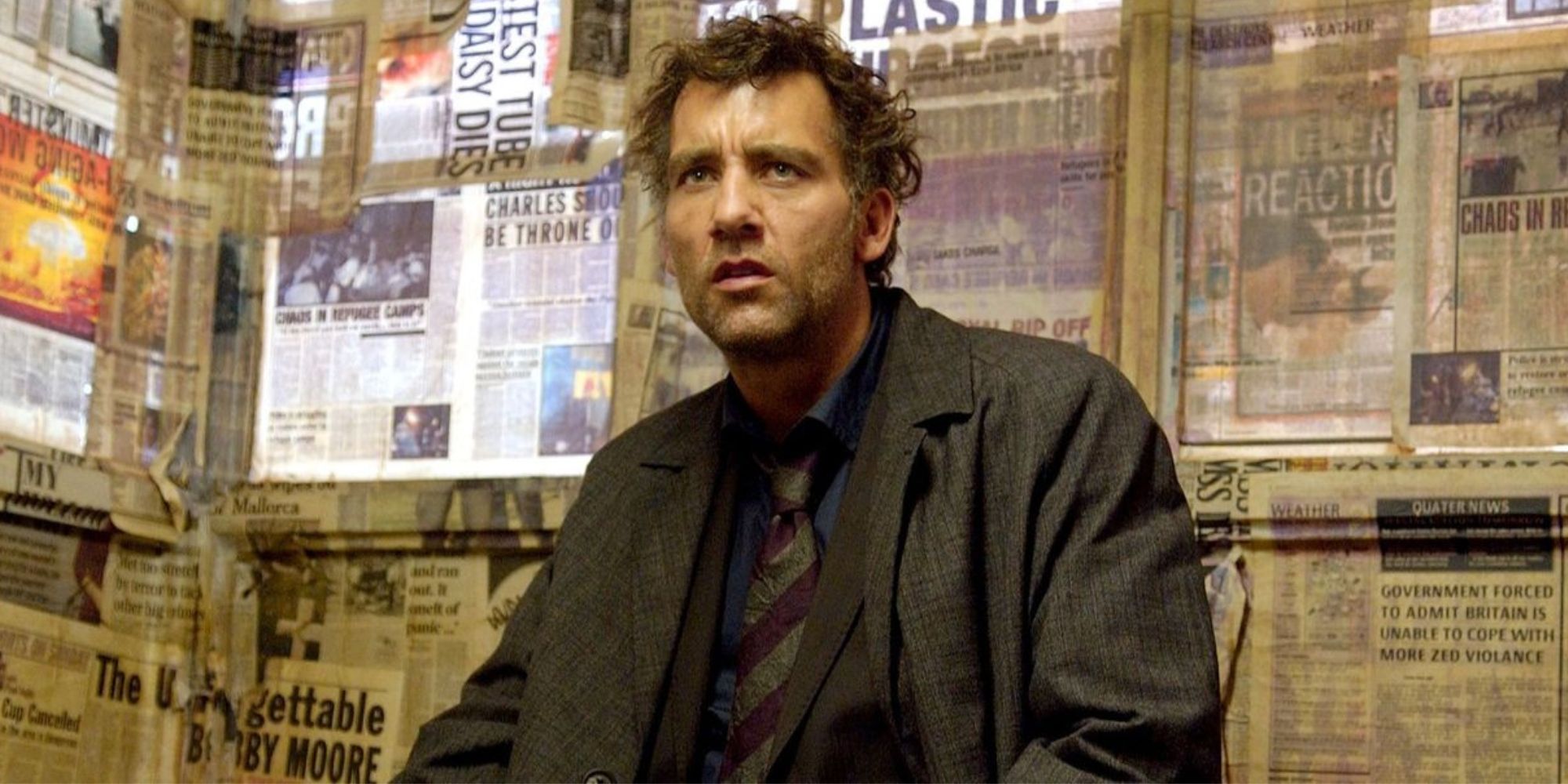 Clive Owen as Theo in a room with newspaper covered windows in Children of Men
