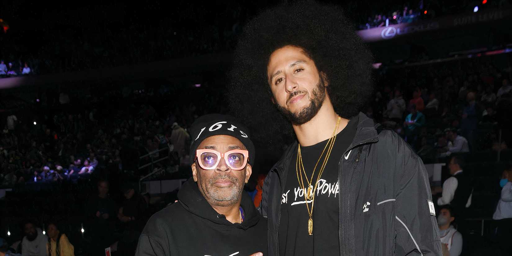 Colin Kaepernick and Spike Lee posing together in front of a crowd