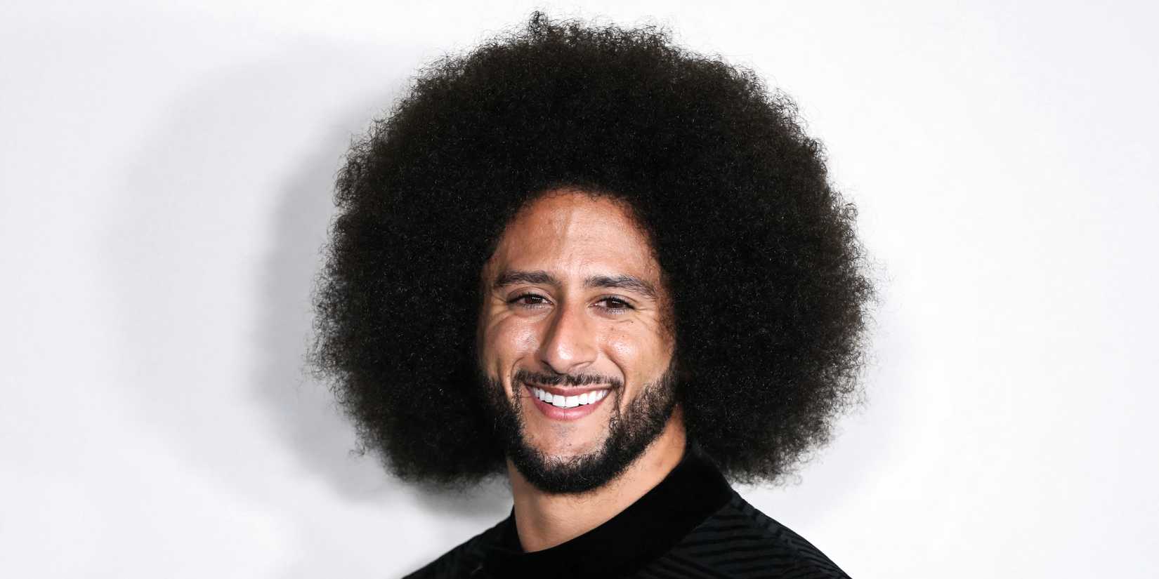 Colin Kaepernick smiling on the red carpet
