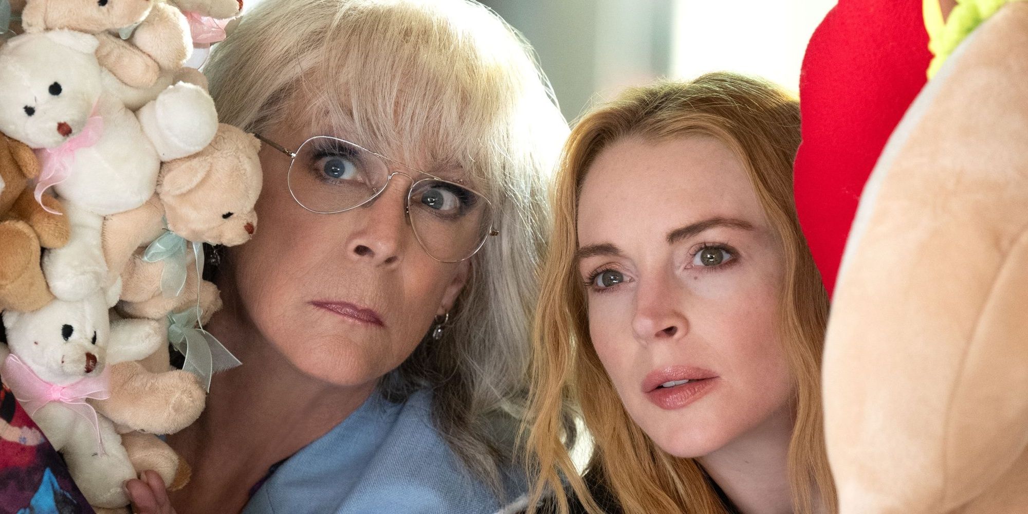 Jamie Lee Curtis and Lindsay Lohan hide behind stuffed animals in Freakier Friday