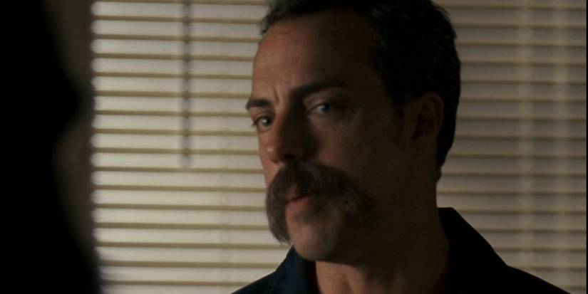 Titus Welliver looks on with a mustache in Gone Baby Gone