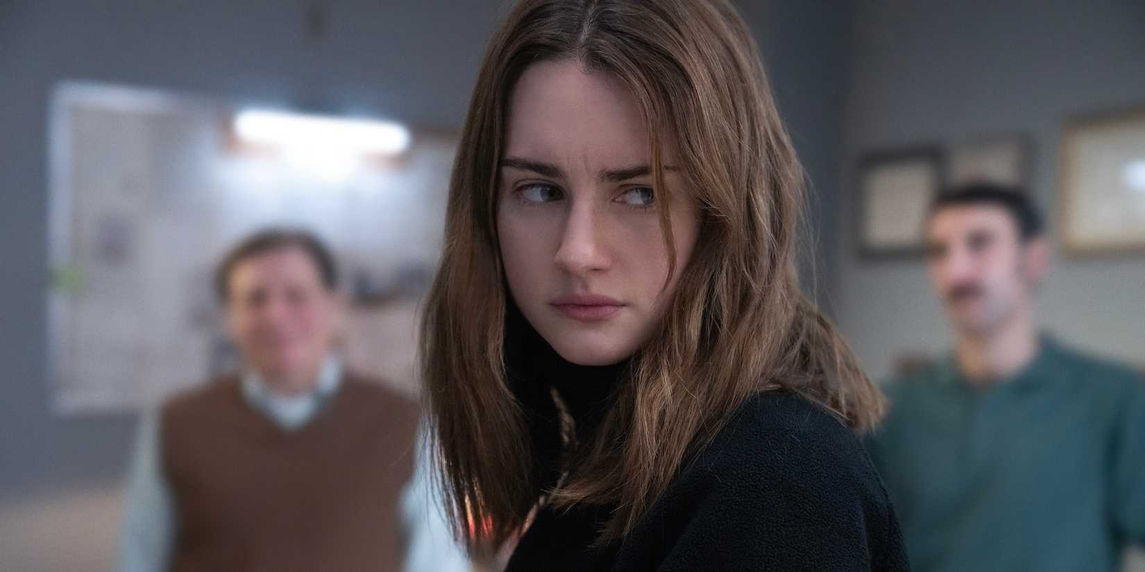 Grace Van Patten's Amanda looking upset over her shoulder in The Twisted Tale of Amanda Knox
