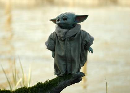 Grogu standing on a log in The Book of Boba Fett