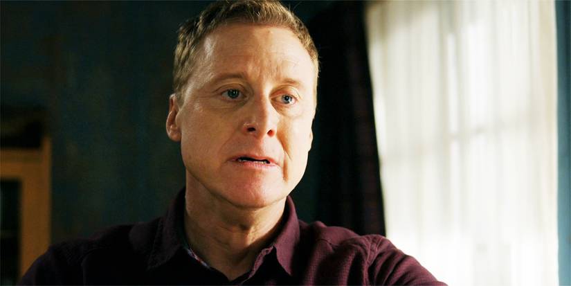 Harry looking sad, after reading a letter, in an episode of Resident Alien