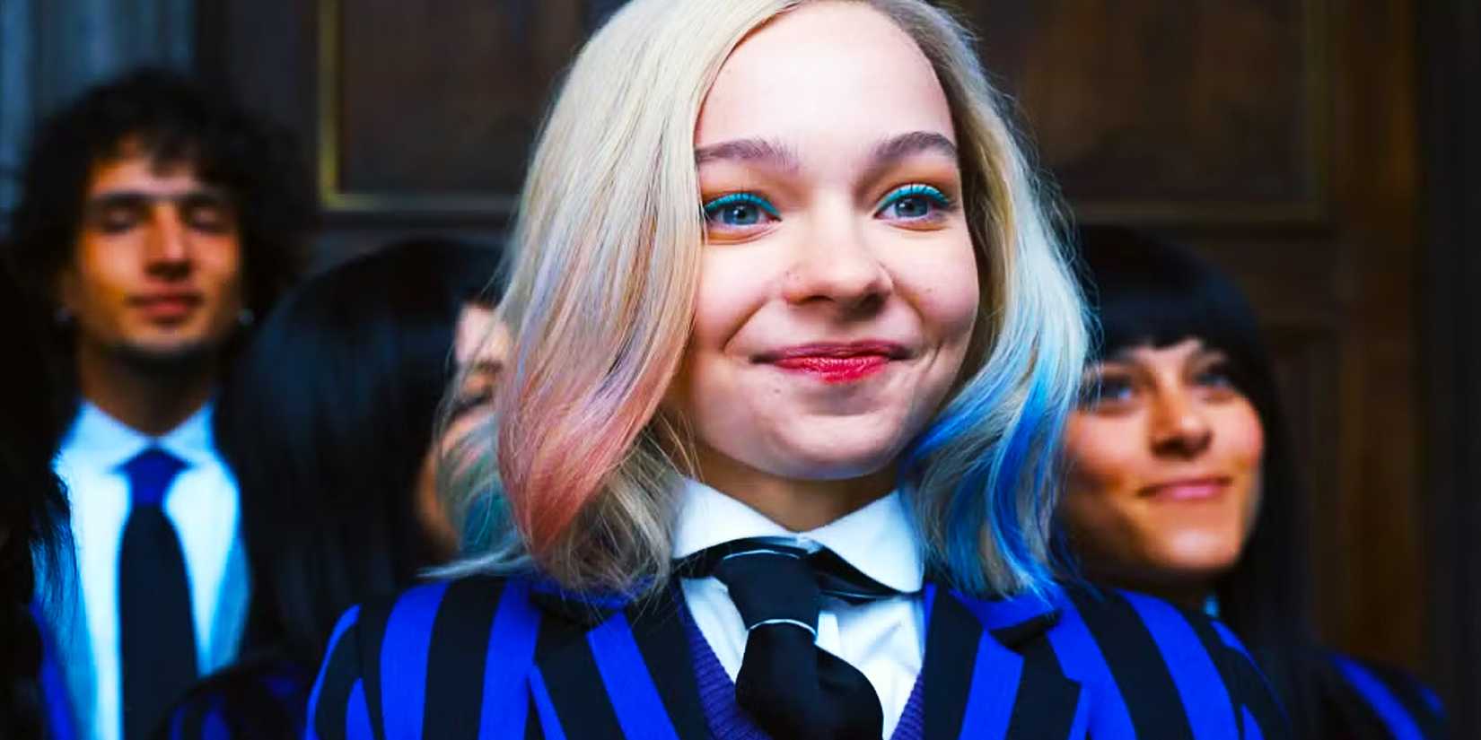 Enid smiles while standing with other Nevermore students in Wednesday season 2