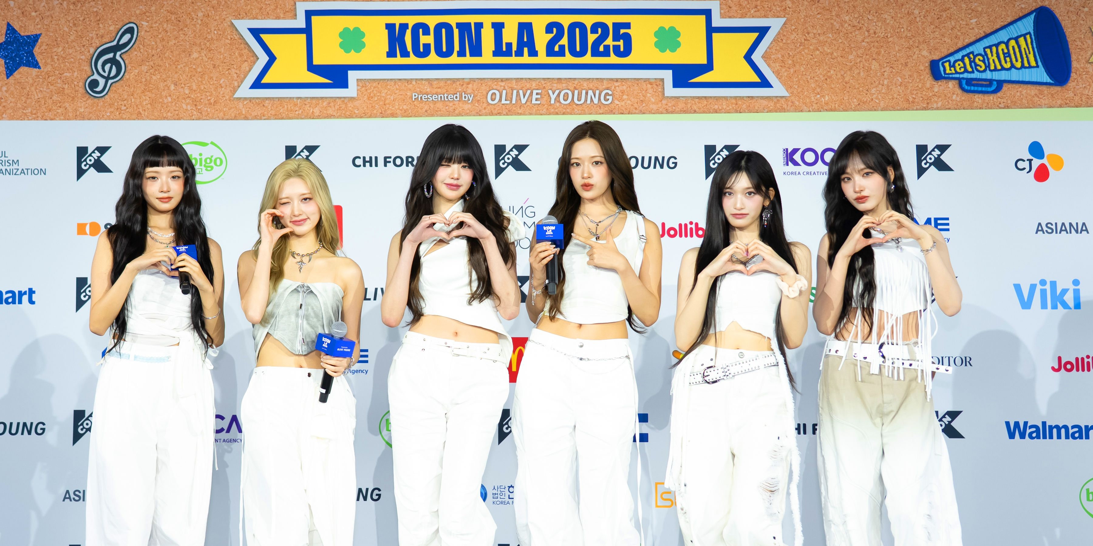 IVE posing in front of the KCON LA 2025 red carpet