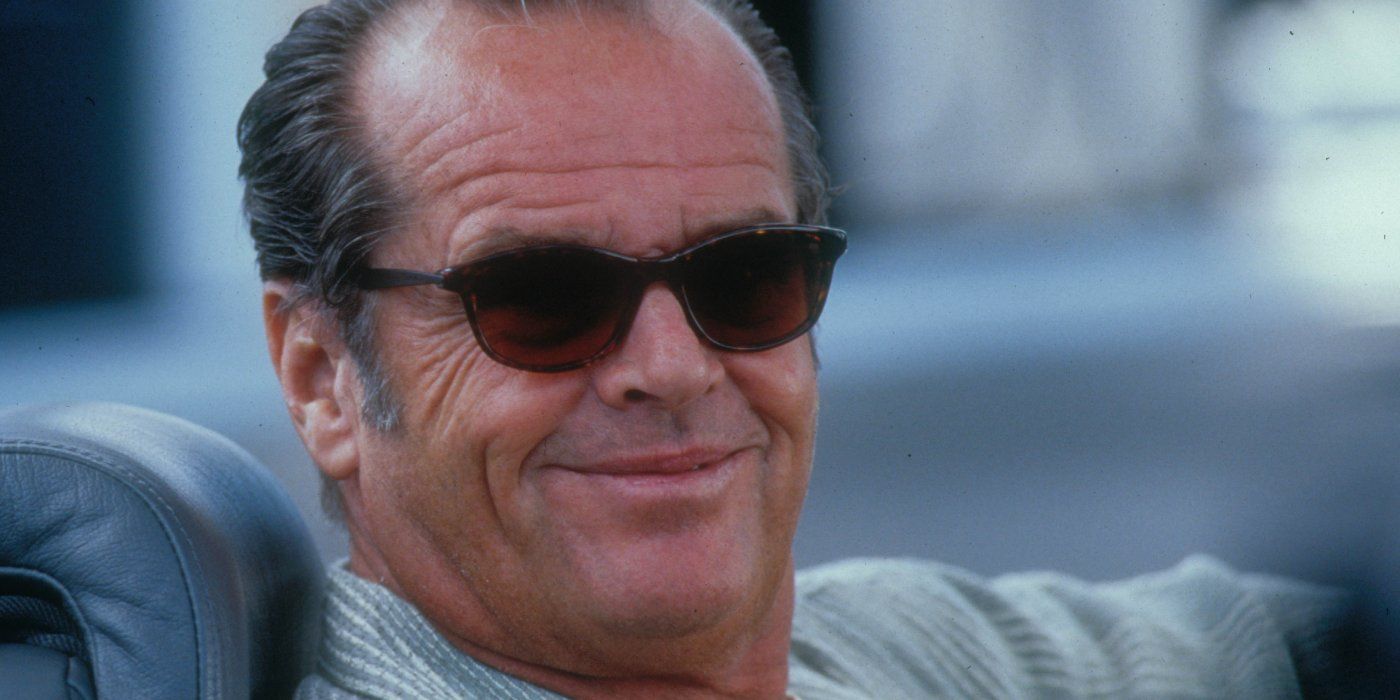 Jack Nicholson smiles whiile driving a car