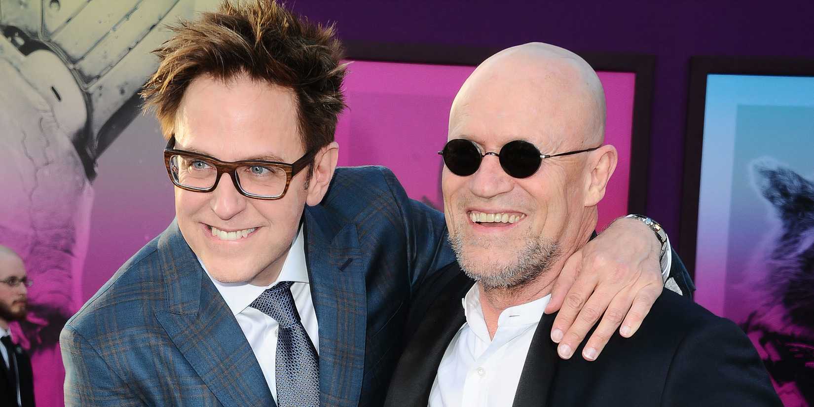 James Gunn and Michael Rooker smiling together on the red carpet