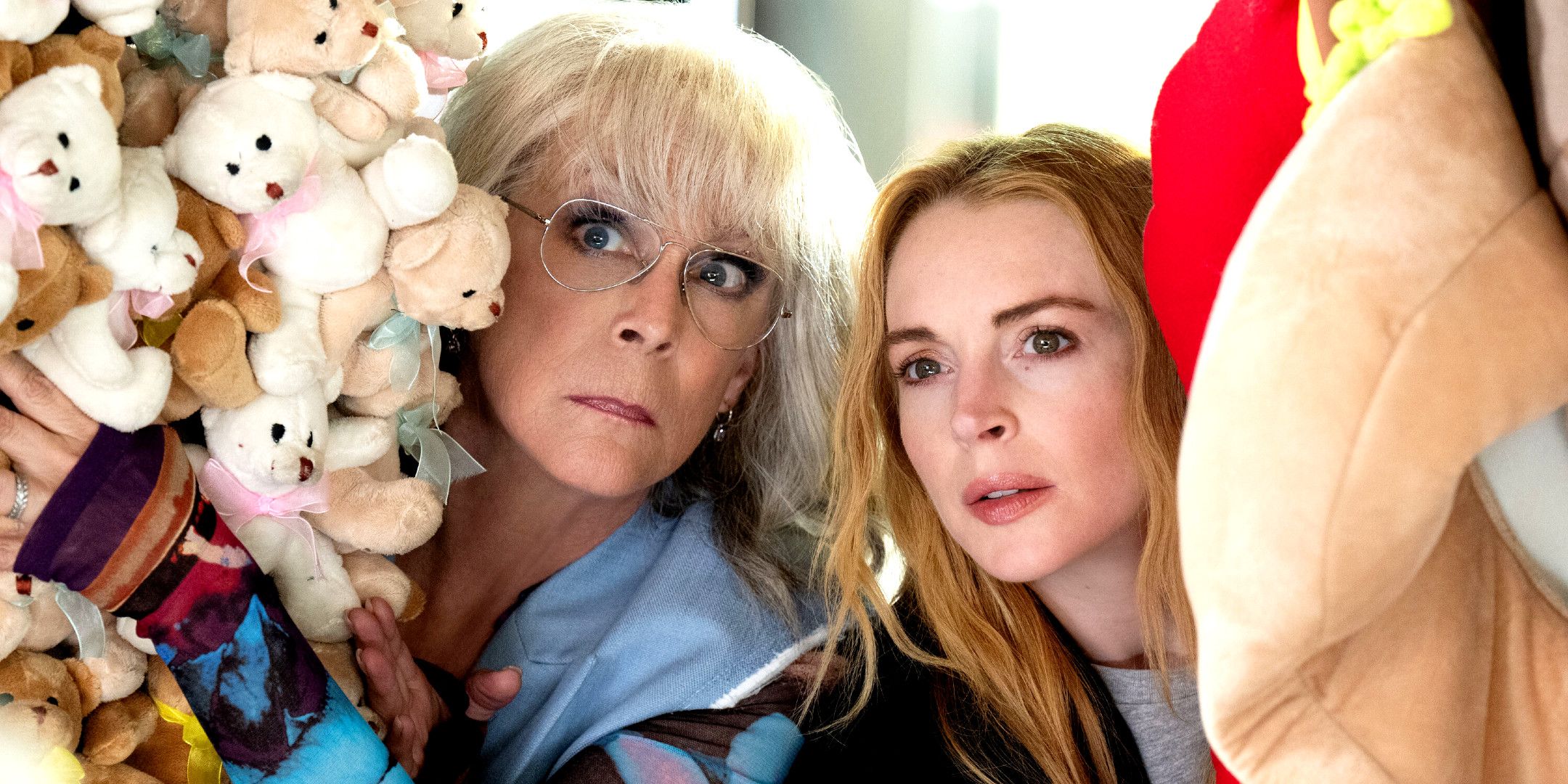 Jamie Lee Curtis and Lindsay Lohan hiding behind stuffed animals in Freakier Friday