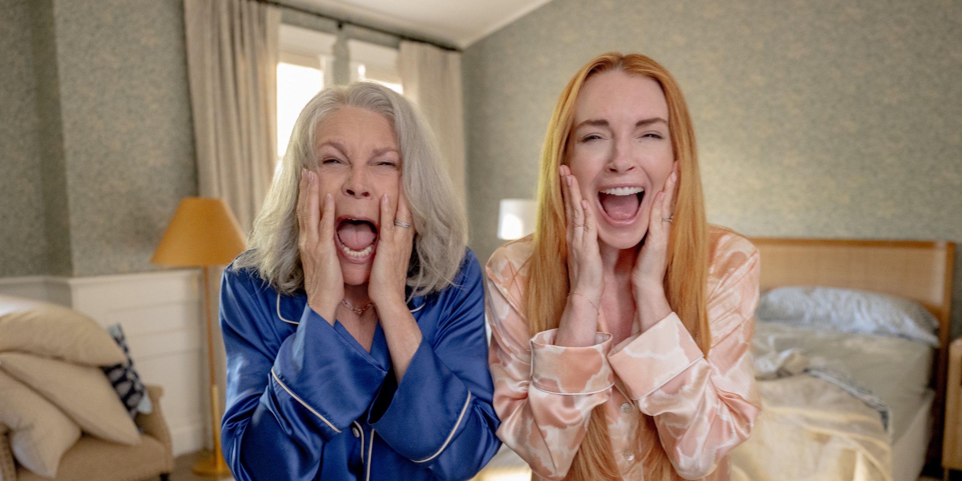 Jamie Lee Curtis and Lindsay Lohan holding their faces and screaming in Freakier Friday