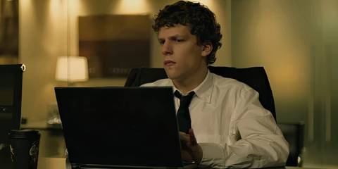 Jesse Eisenberg as Mark Zuckerberg sitting in front of a laptop in The Social Network