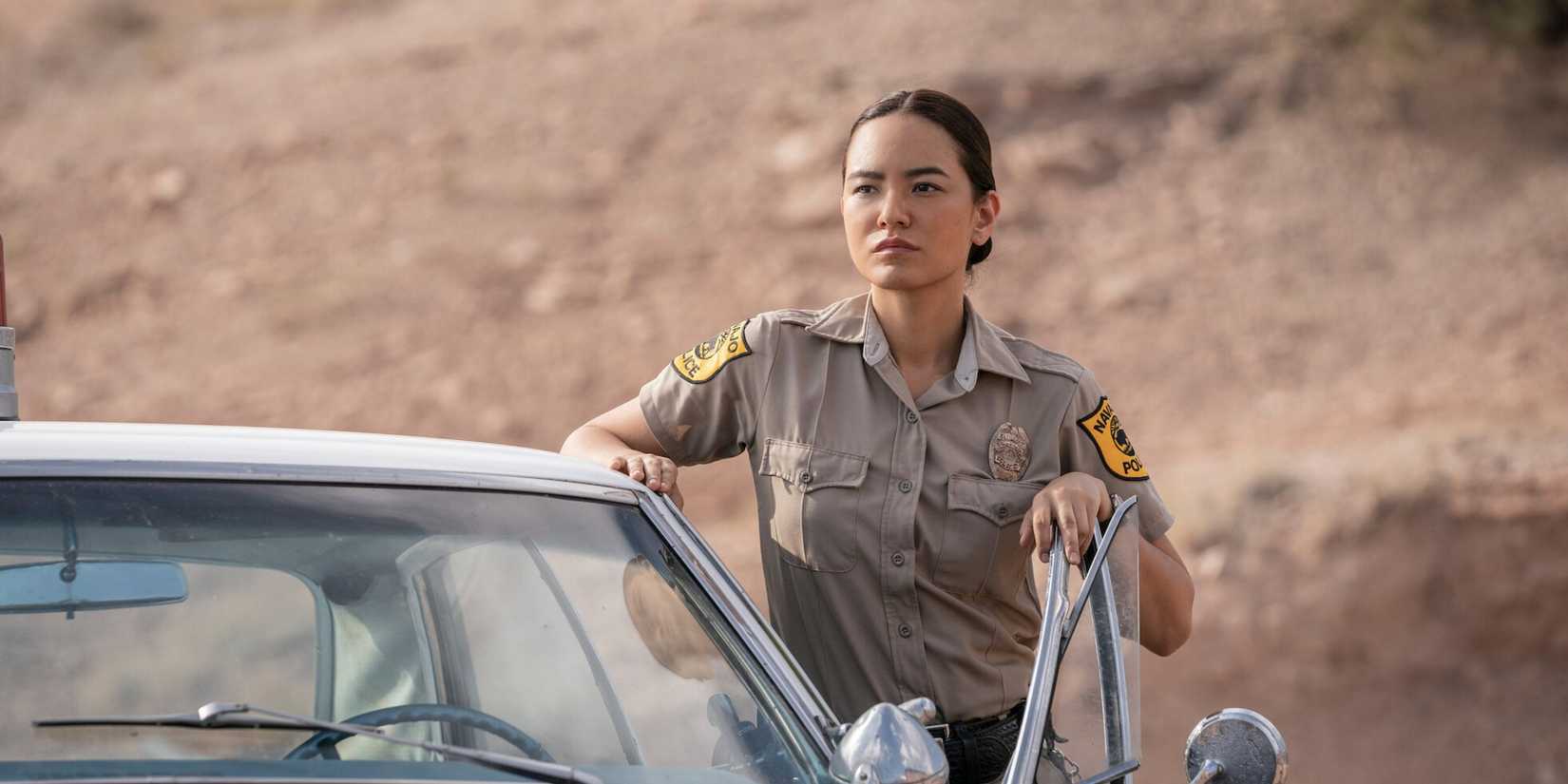 Jessica Matten standing outside a cop car in Dark Winds 