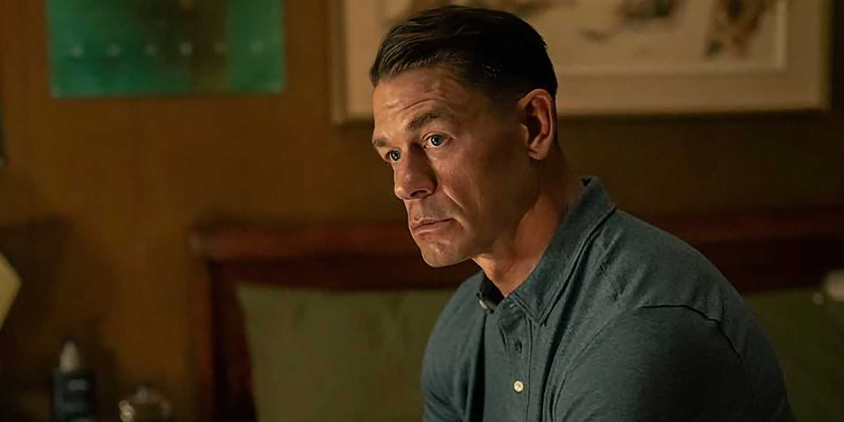 John Cena as Chris looking thoughtfully while sitting on his bed in Peacemaker season 2
