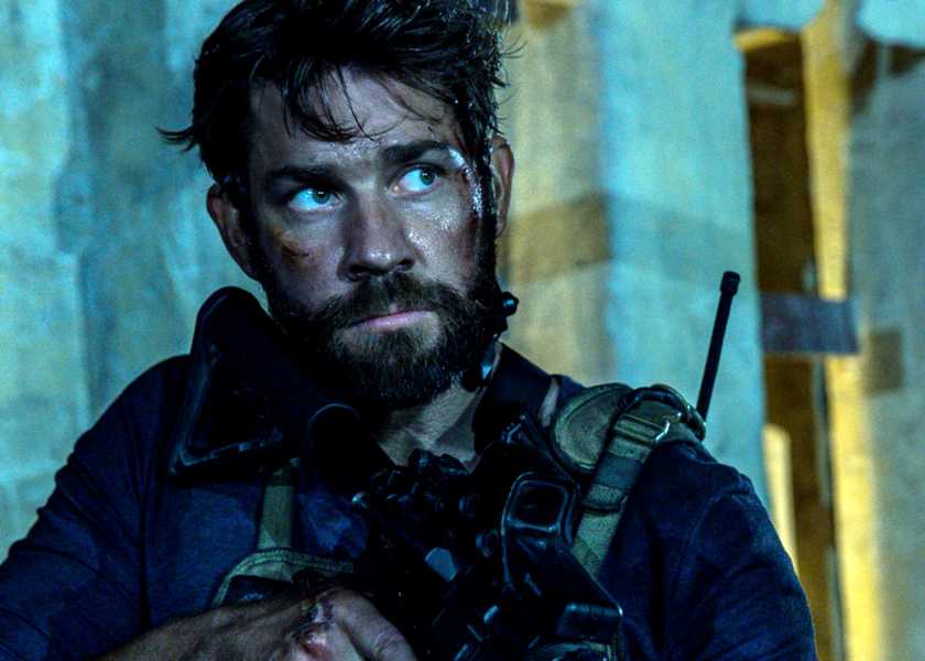 John Krasinski looking serious with a rifle as Jack Silva in 13 Hours The Secret Soldiers of Benghazi